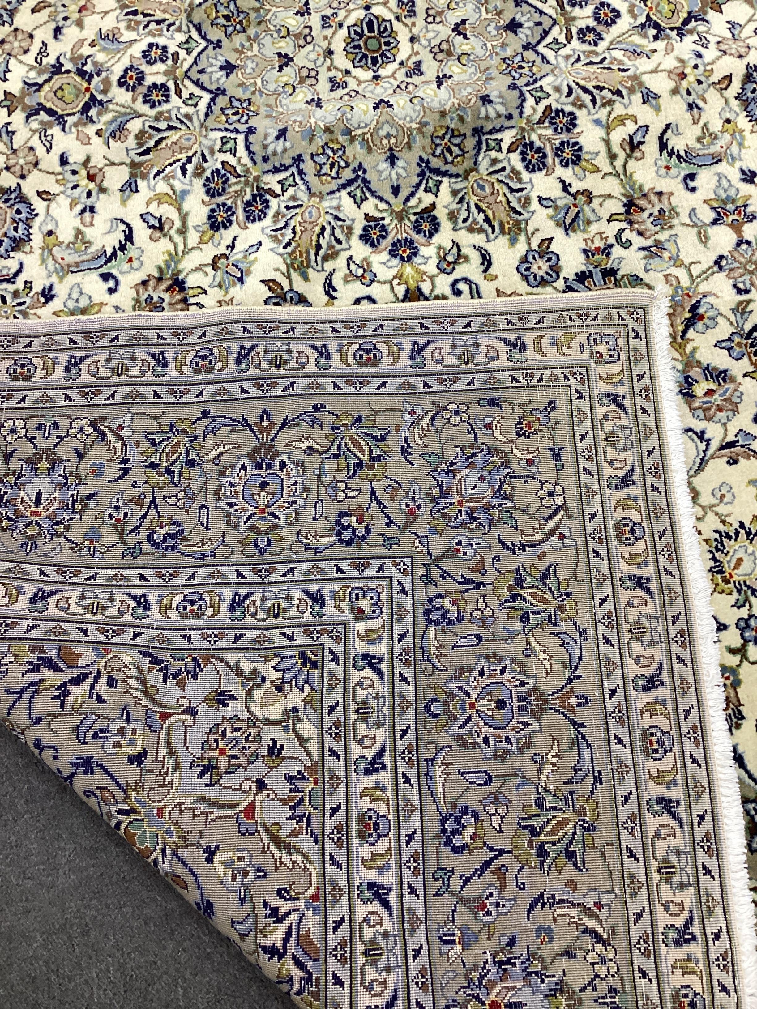 A Kashan ivory ground carpet, 300 x 195cm